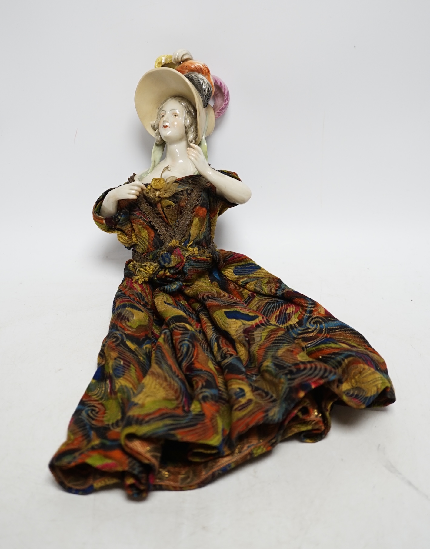 A 1920’s porcelain pin dolly, 18cm high not including dress. Condition - good
